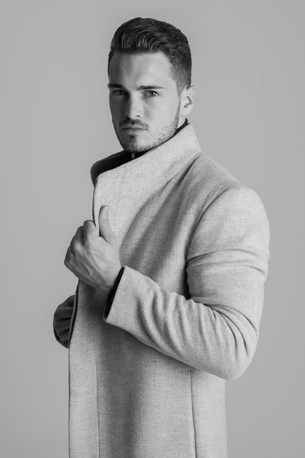 Andreas Schmid, black and white portrait in a light wool coat