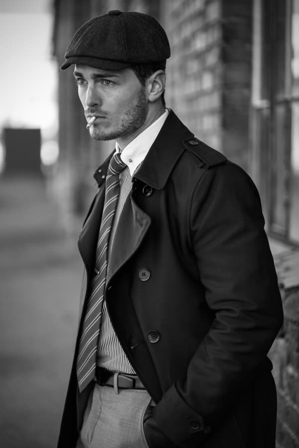 Andreas Schmid, black and white street photo in a flat cap and coat