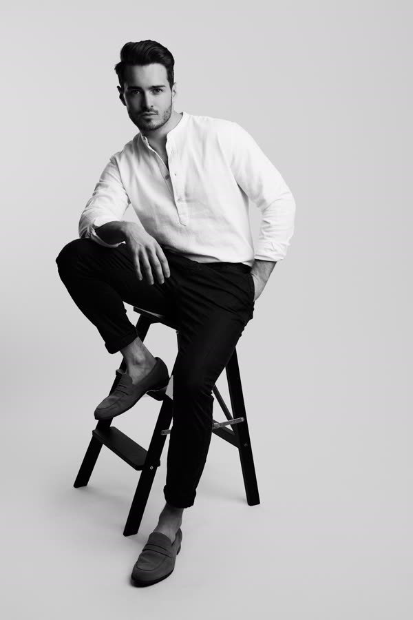 Andreas Schmid, black and white studio photo, seated in a white shirt