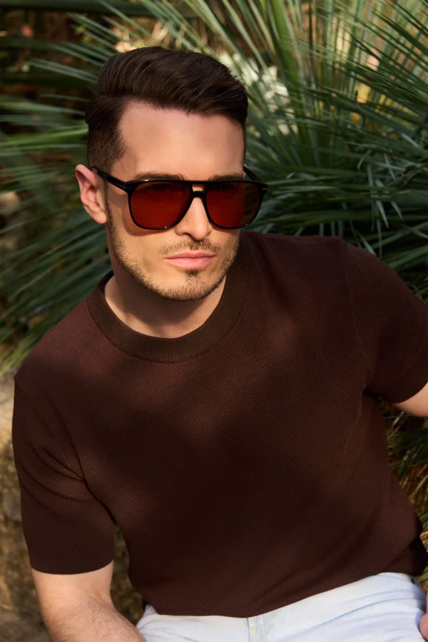 Andreas Schmid, red sunglasses among palm leaves