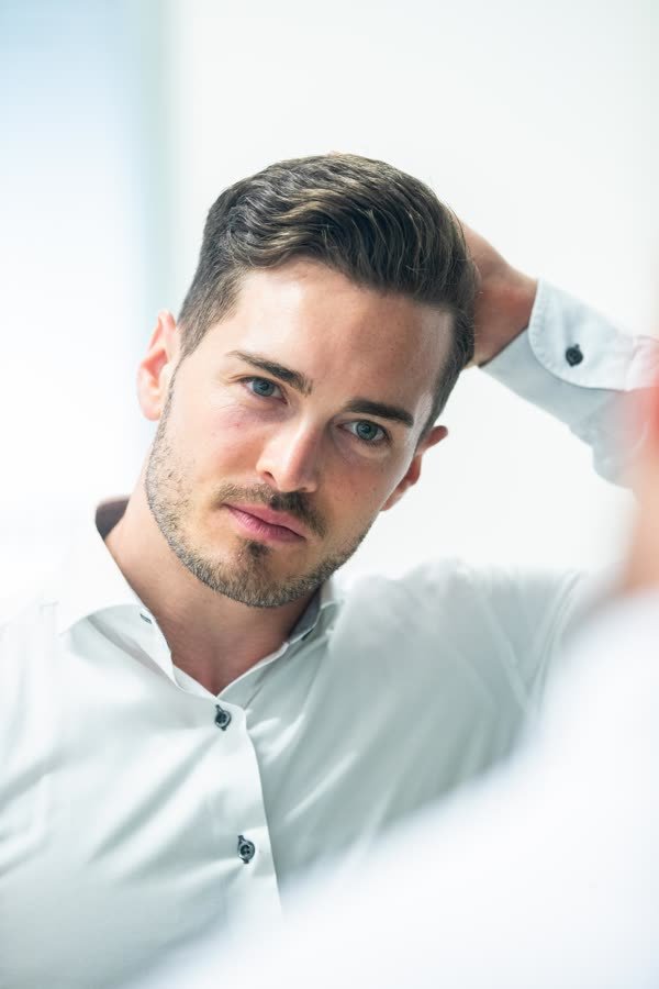 Andreas Schmid in a white shirt, close portrait in daylight